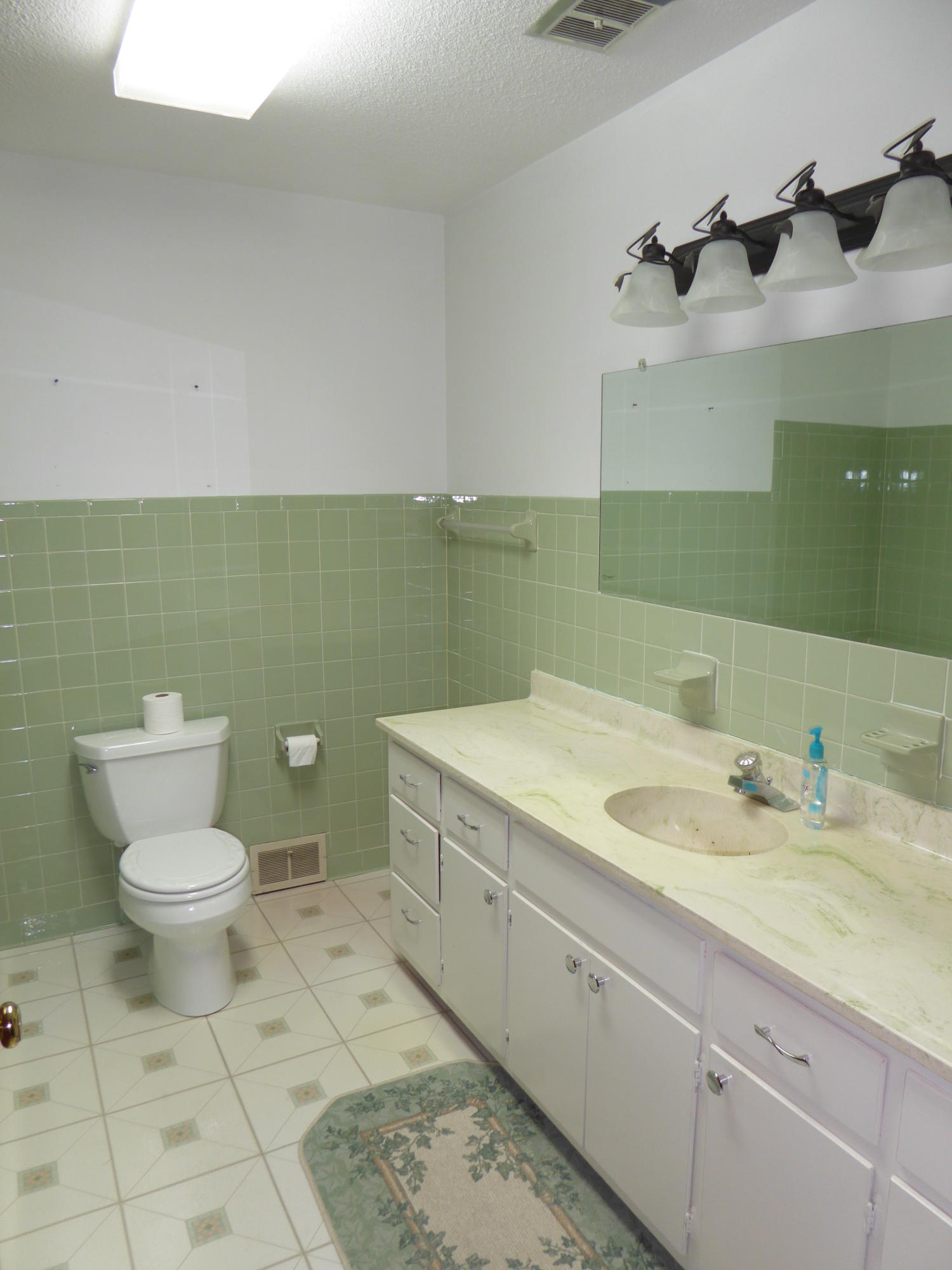 10454 Henry Road Henry, VA 24102 - Photo 58 of 72 a bathroom with a granite countertop toilet sink and mirror