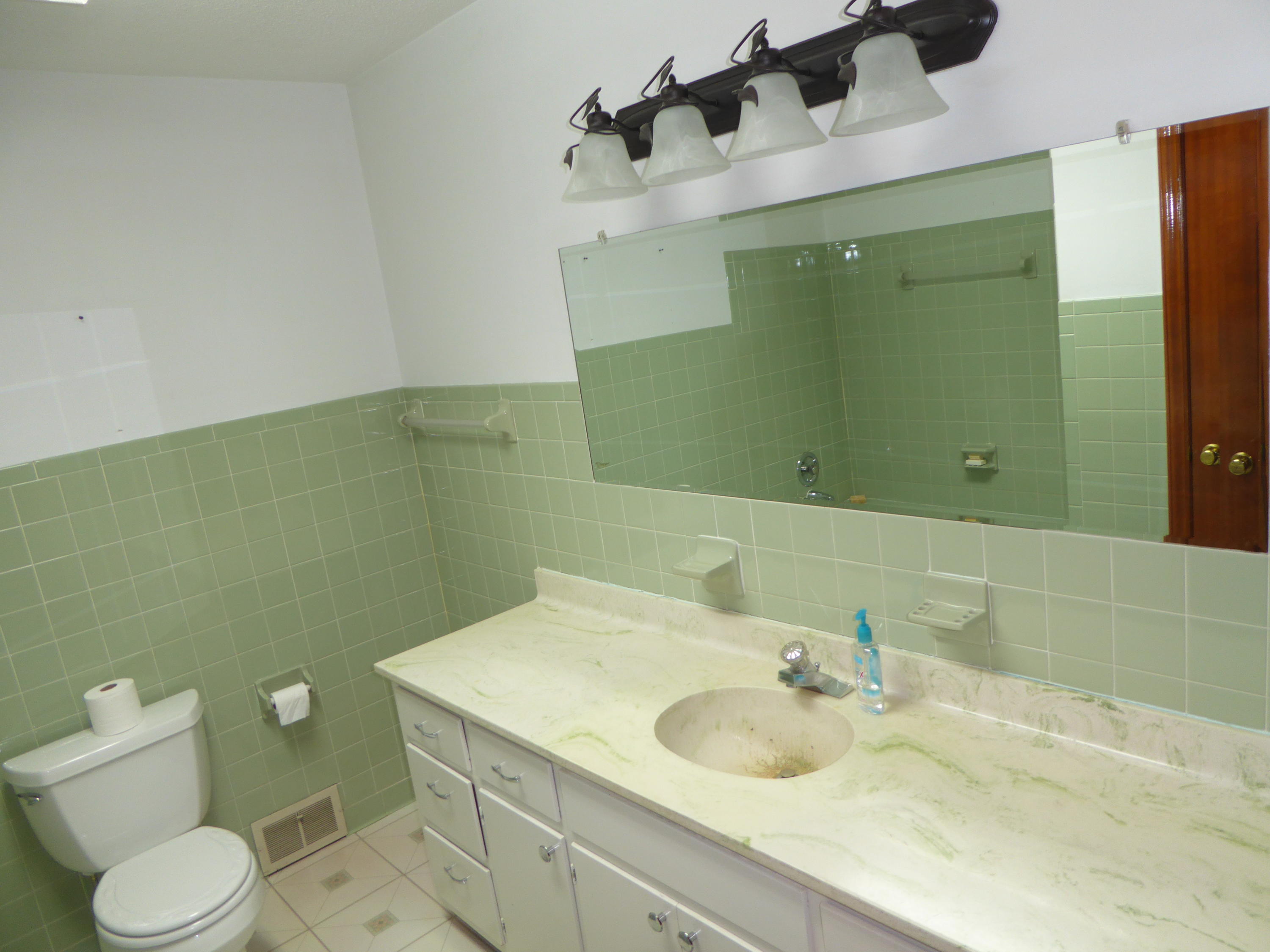 10454 Henry Road Henry, VA 24102 - Photo 59 of 72 a bathroom with a granite countertop toilet sink and mirror
