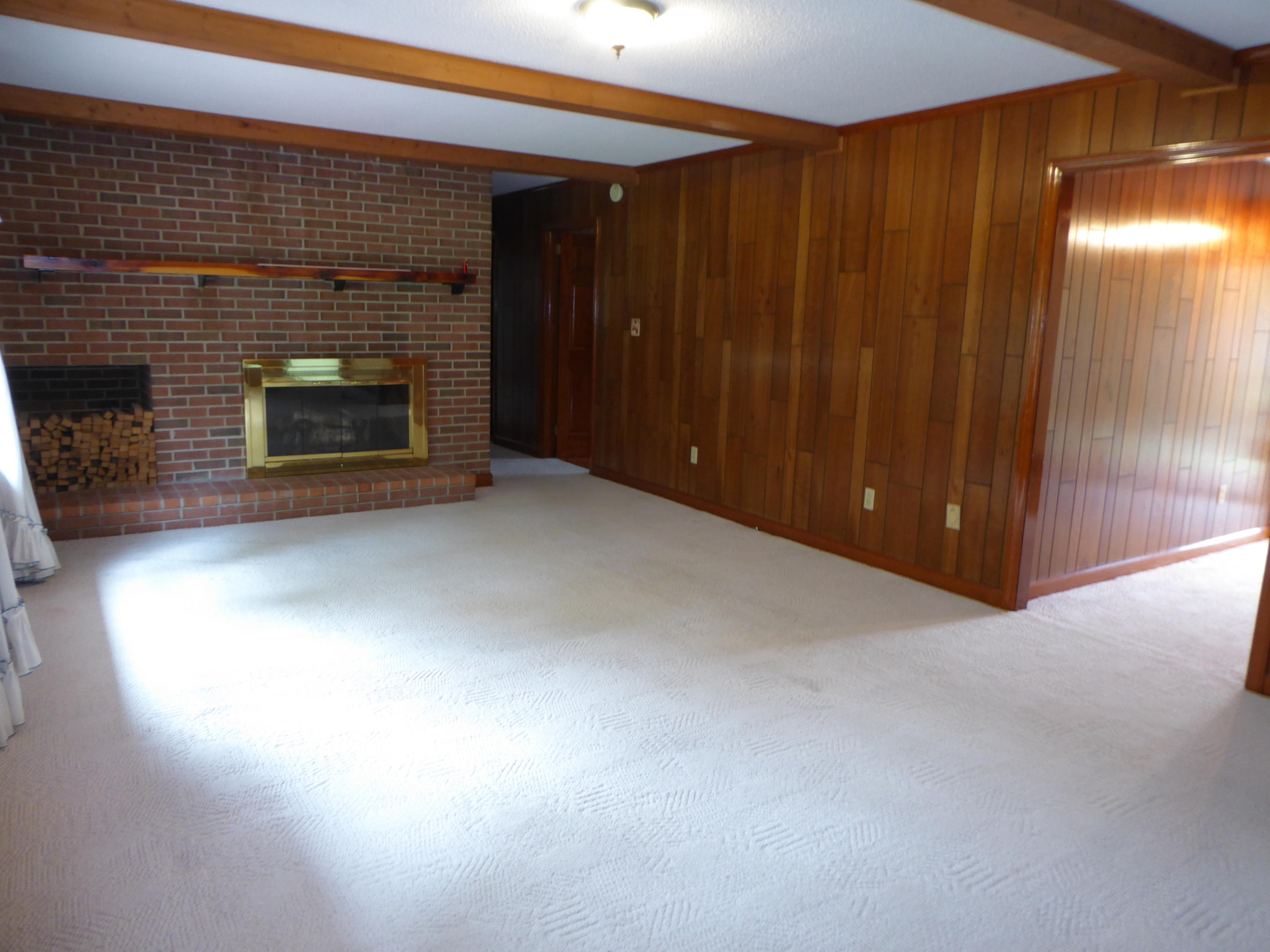 10454 Henry Road Henry, VA 24102 - Photo 61 of 72 a view of an empty room with wooden floor and a fireplace