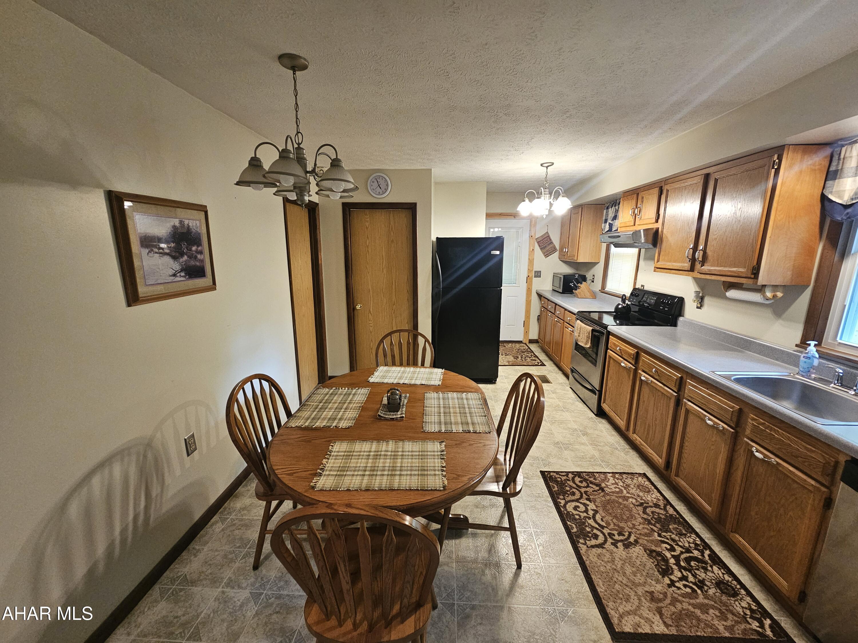 207 Kendrick Lane Flinton, PA 16640 - Photo 12 of 30 a view of a dining room with furniture window and wooden floor