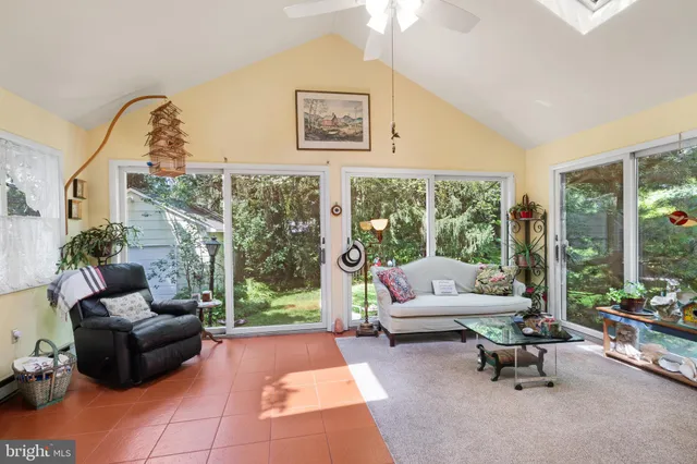a living room with furniture a fireplace and a large window