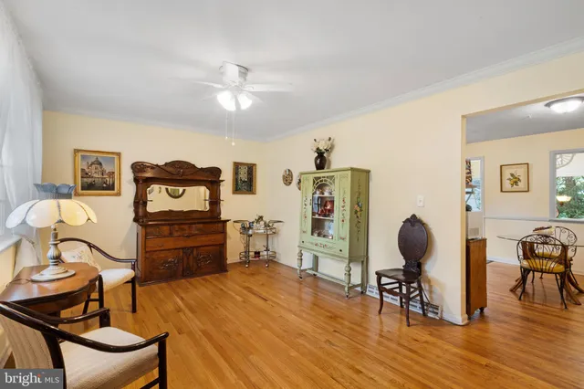 a kitchen with stainless steel appliances kitchen island granite countertop a refrigerator a stove a sink and dishwasher a dining table with wooden floor