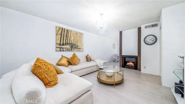 a kitchen with stainless steel appliances granite countertop white cabinets sink and a granite counter top