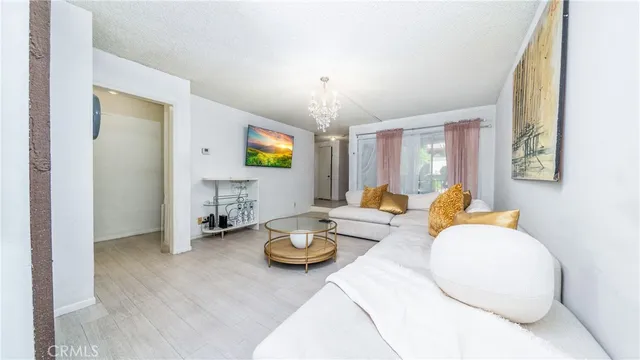 a kitchen with stainless steel appliances granite countertop a refrigerator a stove a sink and a microwave