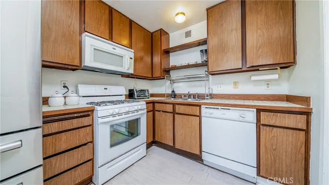 a spacious bedroom with a bed and a chandelier
