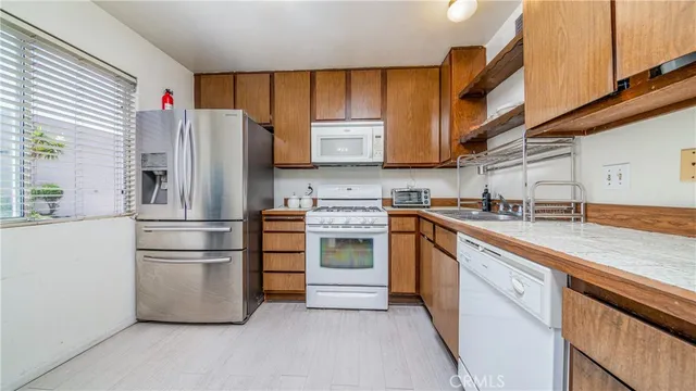 a spacious bedroom with a bed and a chandelier