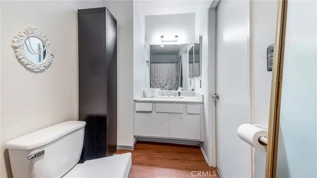 a bathroom with a toilet and a shower curtain