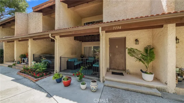a balcony with furniture and a potted plant