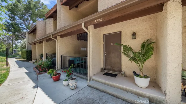 a wooden bench sitting in front of a building