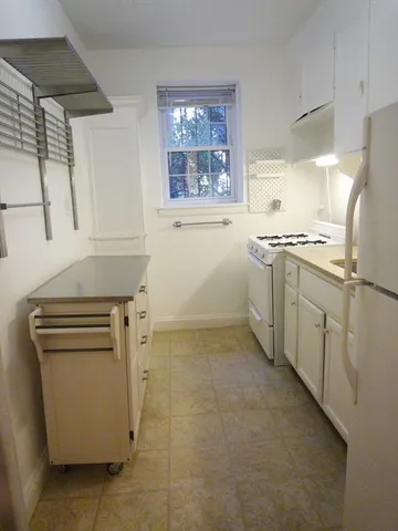 a kitchen with a stove sink and cabinets