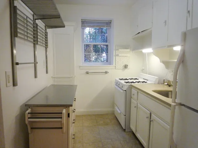 a kitchen with a sink and a stove top oven