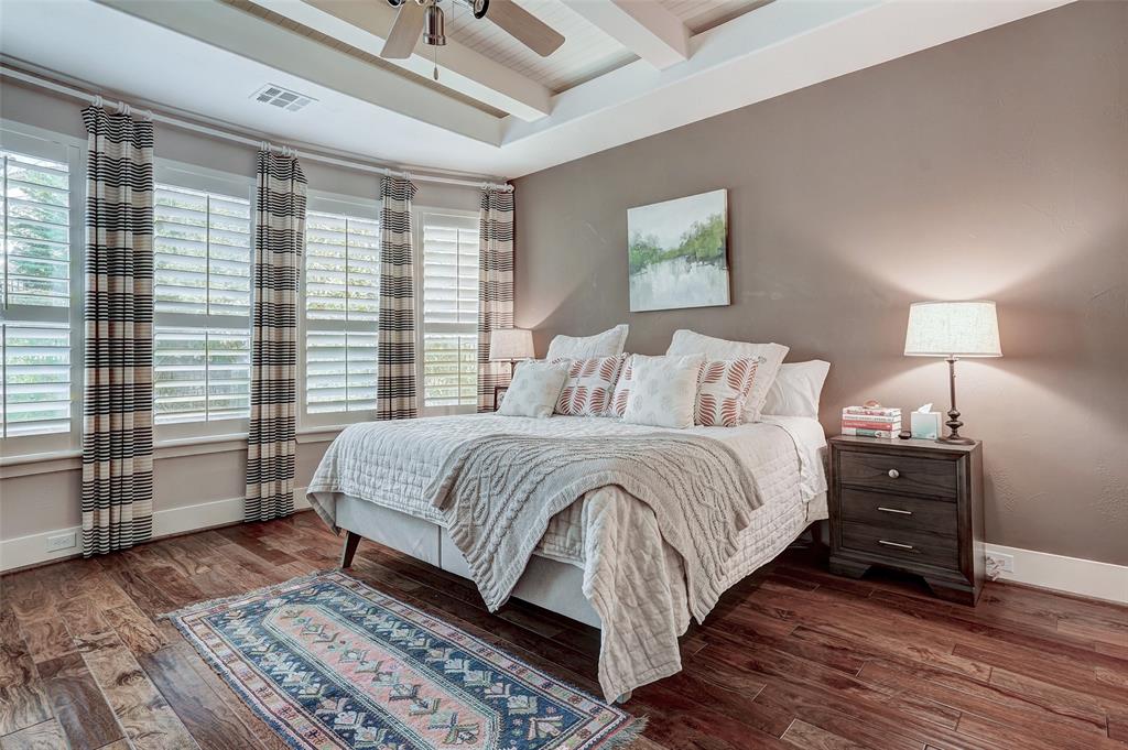 4501 Westlake Drive, Unit 23 Austin, TX 78746 - Photo 7 of 15 a bedroom with a bed and wooden floor