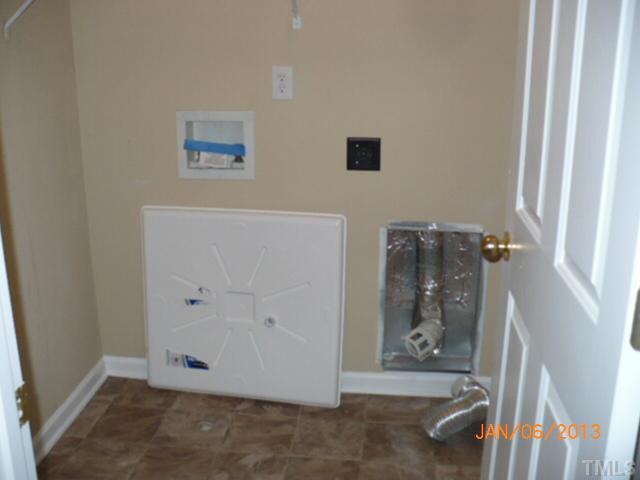 2512 Spruce Shadows Lane Raleigh, NC 27614 - Photo 15 of 22 an empty room with wooden floor and entrance