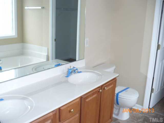 2512 Spruce Shadows Lane Raleigh, NC 27614 - Photo 17 of 22 a bathroom with a sink and a mirror
