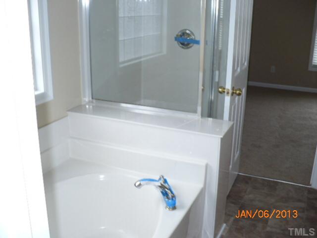 2512 Spruce Shadows Lane Raleigh, NC 27614 - Photo 18 of 22 a bathroom with a bathtub