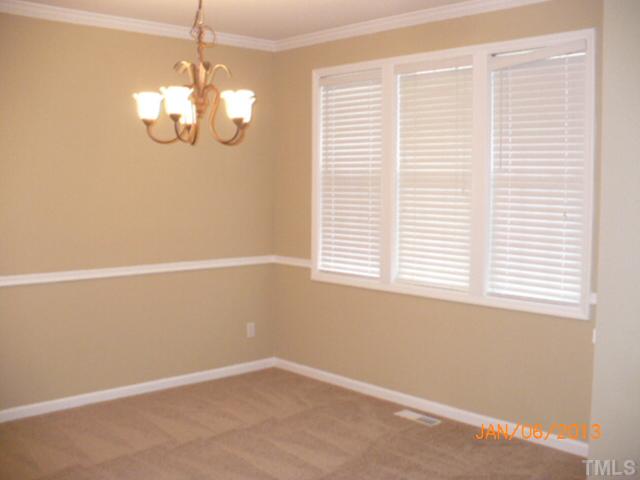 2512 Spruce Shadows Lane Raleigh, NC 27614 - Photo 4 of 22 en empty room with windows