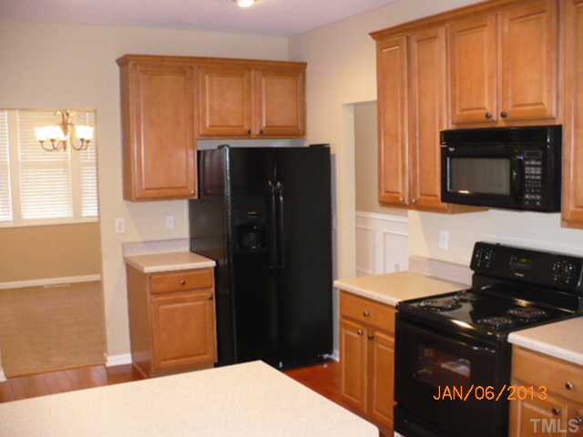 2512 Spruce Shadows Lane Raleigh, NC 27614 - Photo 5 of 22 a kitchen with a refrigerator stove and microwave