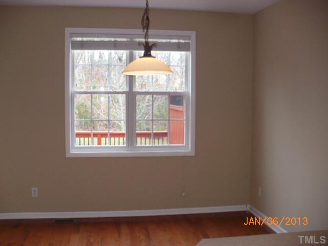 2512 Spruce Shadows Lane Raleigh, NC 27614 - Photo 6 of 22 a room with wooden floor and a window