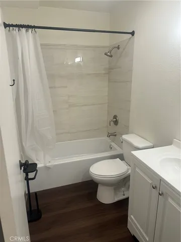 a bathroom with a sink a toilet a mirror and shower