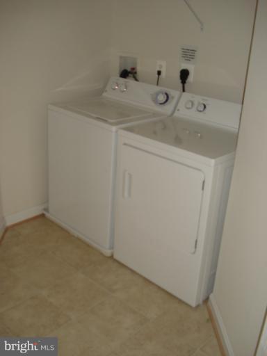 7305 Maplecrest Road, Unit 403 Elkridge, MD 21075 - Photo 1 of 30 a utility room with dryer and washer