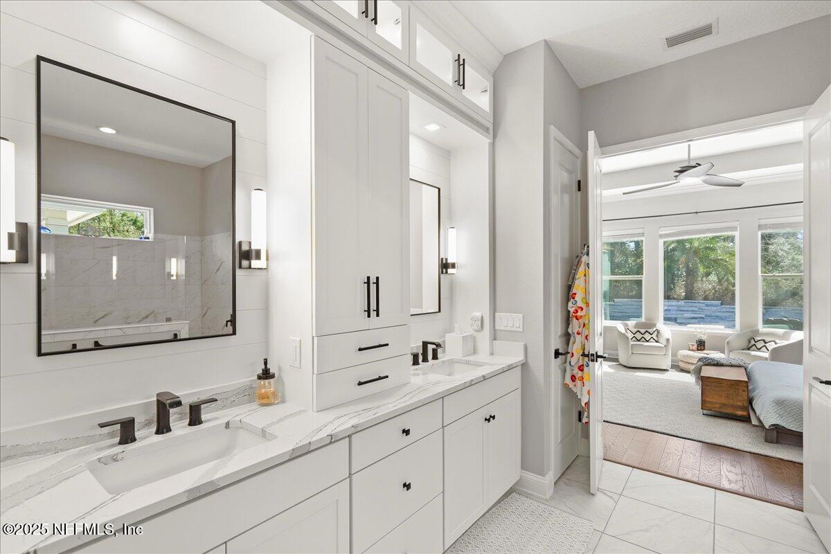 470 Parkbluff Circle Ponte Vedra, FL 32081 - Photo 33 of 42 a en suite bathroom with double sink a large mirror and a window