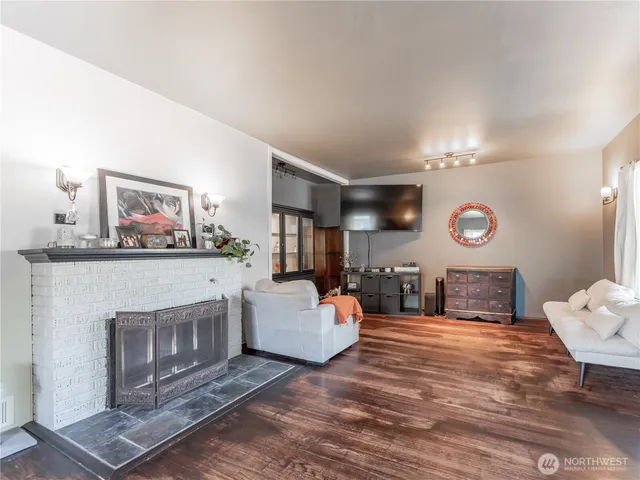 a dining room with furniture and wooden floor