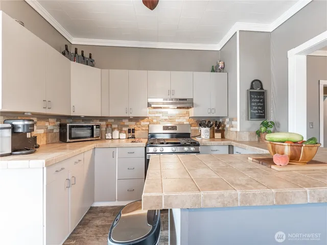 a kitchen with a stove a sink and a refrigerator