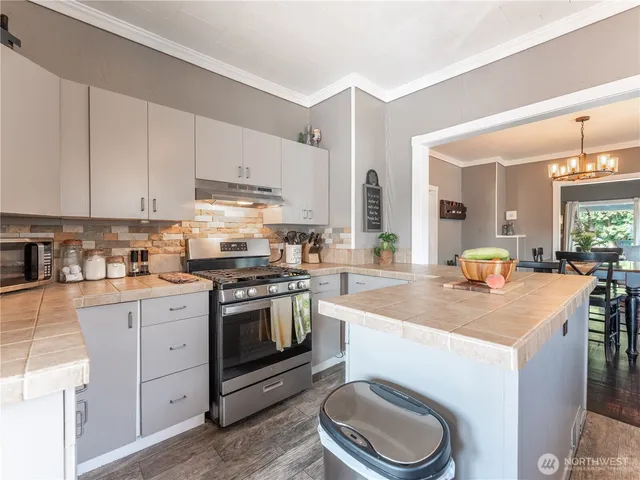 a kitchen with counter top space and windows