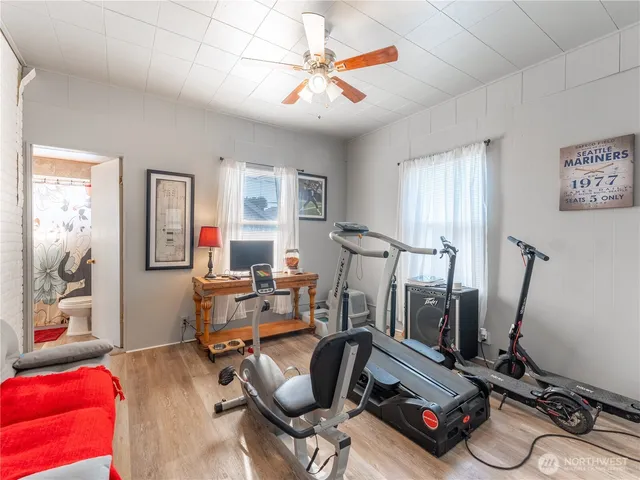 a view of a hallway with wooden floor and entryway