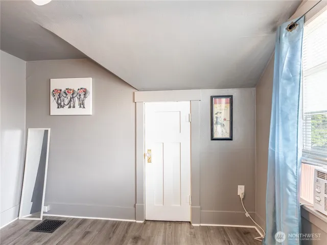 a bedroom with a large bed and a tv