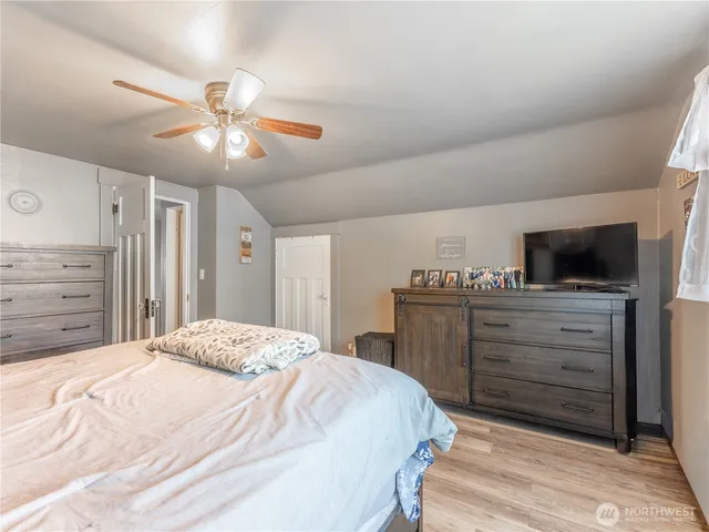 a bedroom with a bed and a chandelier