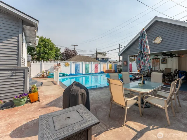 a backyard of a house with table and chairs