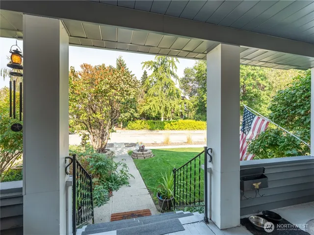 a view of a porch with furniture and garden