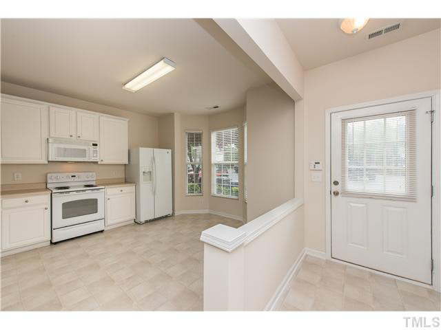 5605 Amanda Lynn Lane Raleigh, NC 27613 - Photo 3 of 25 a kitchen with white cabinets and white appliances