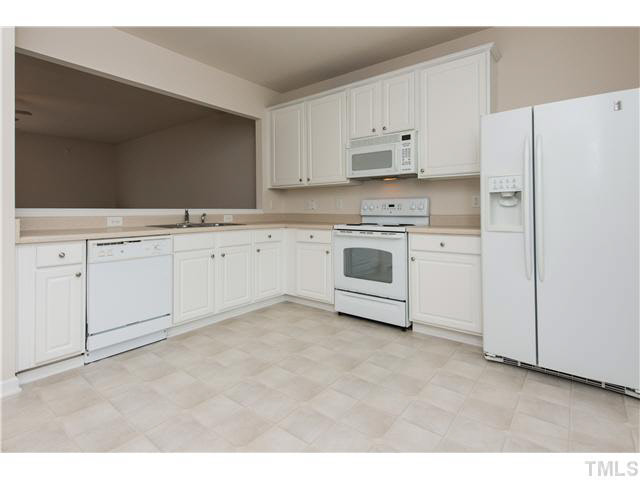 5605 Amanda Lynn Lane Raleigh, NC 27613 - Photo 5 of 25 a kitchen with granite countertop white cabinets and white appliances