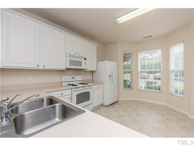 5605 Amanda Lynn Lane Raleigh, NC 27613 - Photo 7 of 25 a kitchen with a refrigerator sink and cabinets