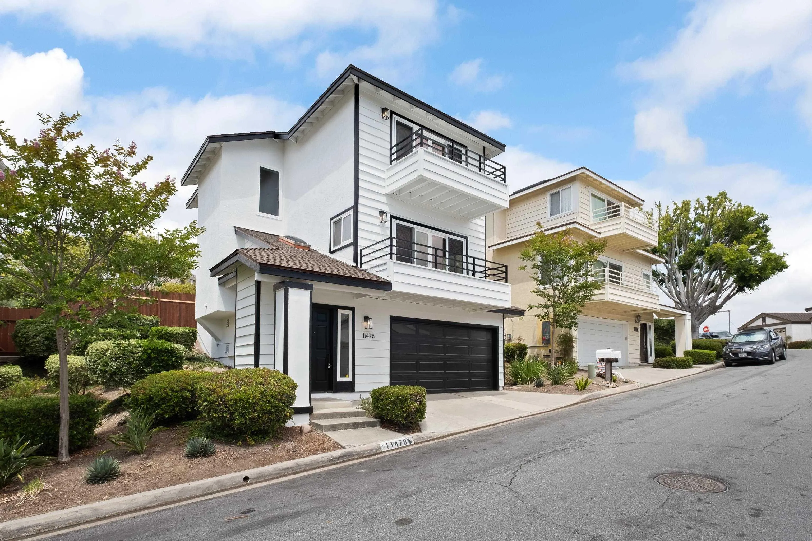 11478 Madera Rosa Way San Diego, CA 92124 - Photo 1 of 54 a view of a white house with a large windows and a yard