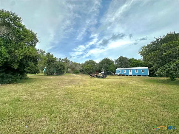 a view of a big yard with an trees