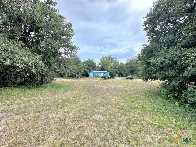 a view of outdoor space with trees all around