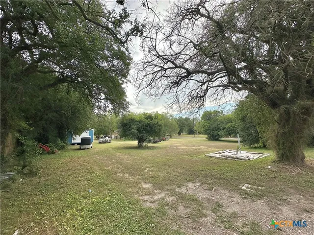 a view of outdoor space with playground and green space