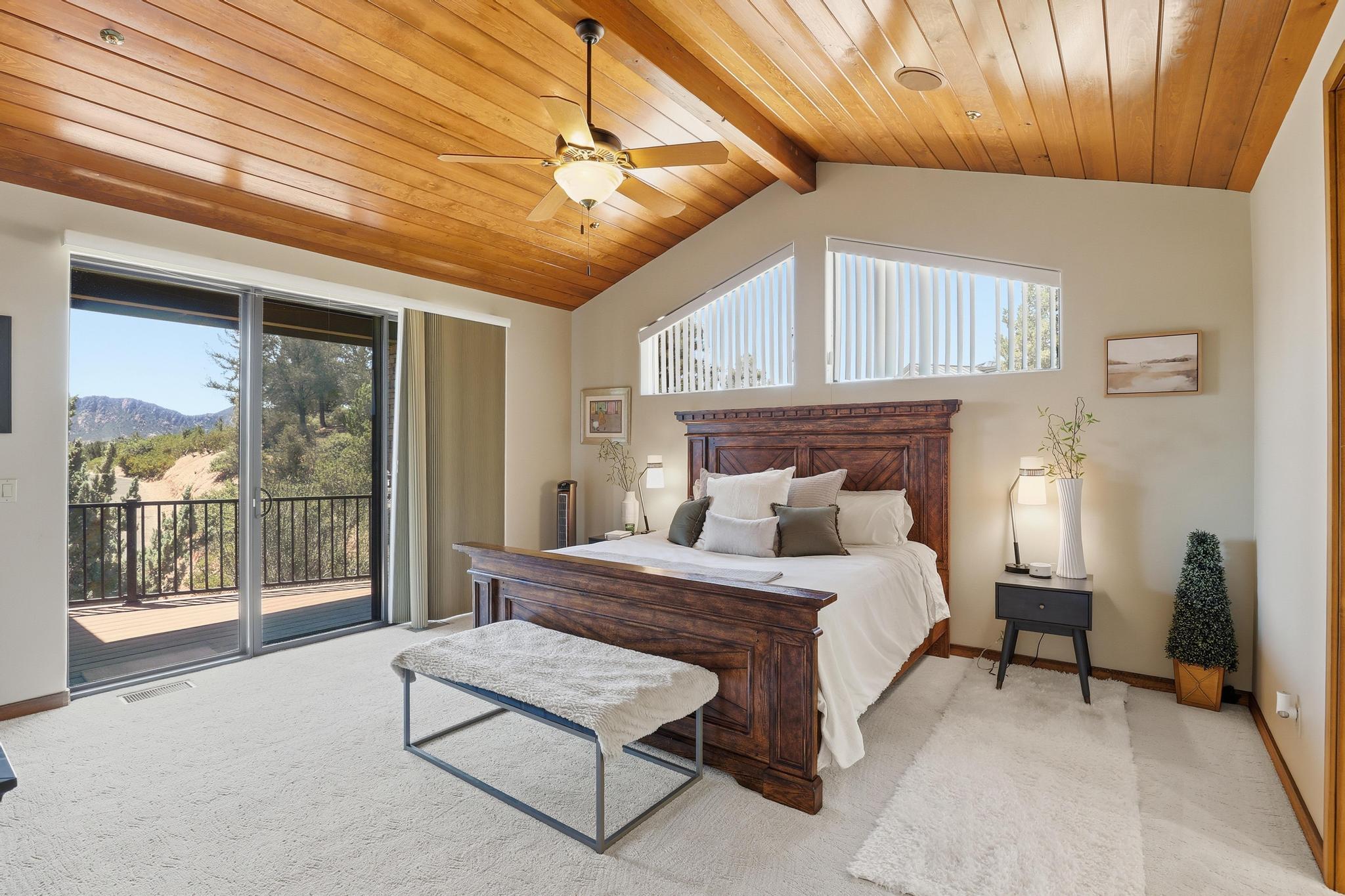 2908 East Rim Club Drive Payson, AZ 85541 - Photo 28 of 77 a bedroom with a bed a chandelier and next to a window