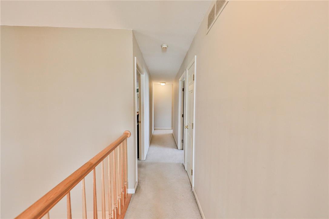 63 Long Road Lenhartsville, PA 19534 - Photo 72 of 100 Warm neutral walls and carpeted flooring define this straightforward second-floor hallway layout.