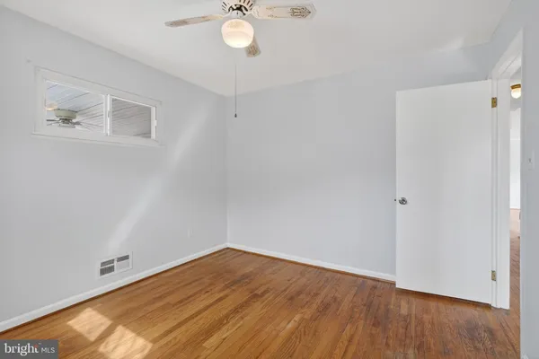 a view of a room with furniture large windows and a chandelier