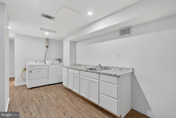 a bathroom with a granite countertop toilet and a sink