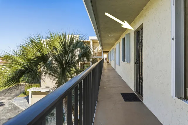 a living room with furniture and a lamp