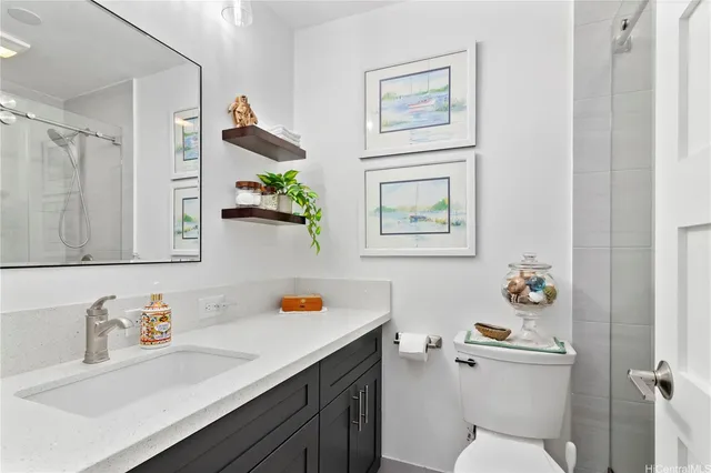 a bathroom with a sink mirror vanity and toilet