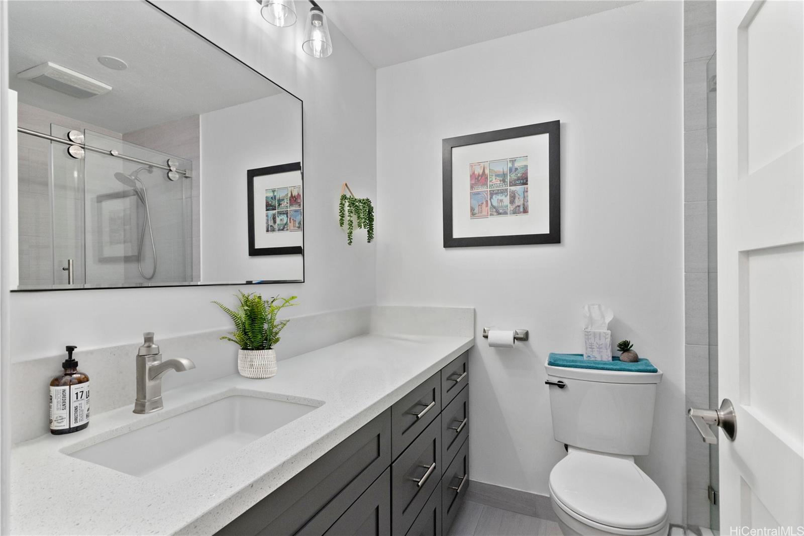 444 Lunalilo Home Road, Unit 327 Honolulu, HI 96825 - Photo 10 of 15 a bathroom with a granite countertop sink mirror and toilet