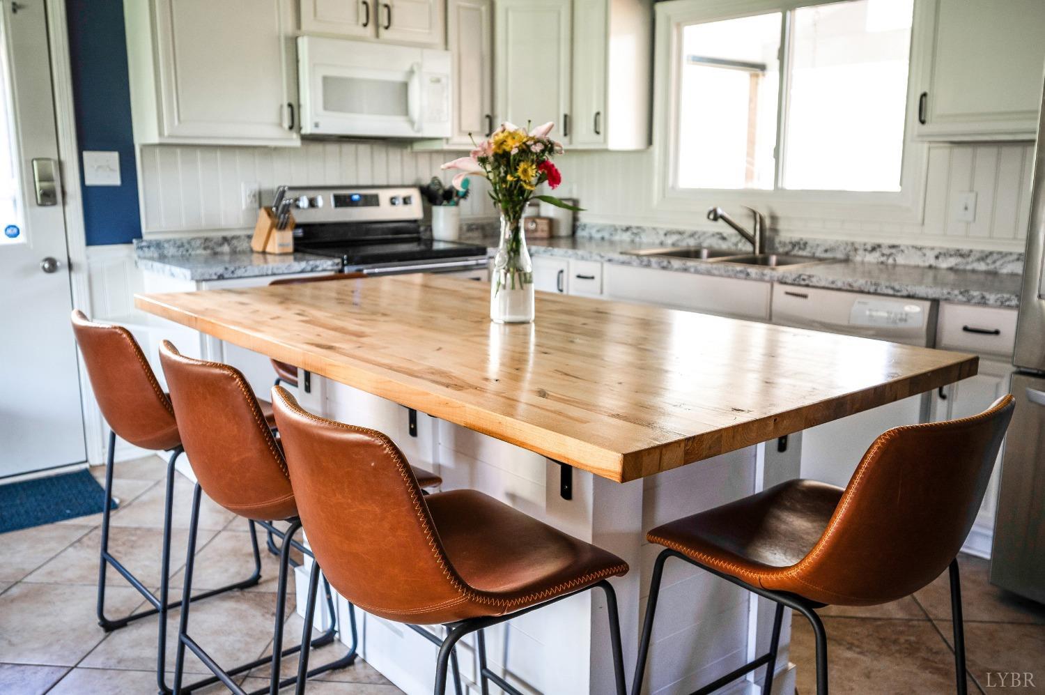 503 Sweeney Circle Forest, VA 24551 - Photo 8 of 50 a kitchen with stainless steel appliances granite countertop a table chairs sink and cabinets