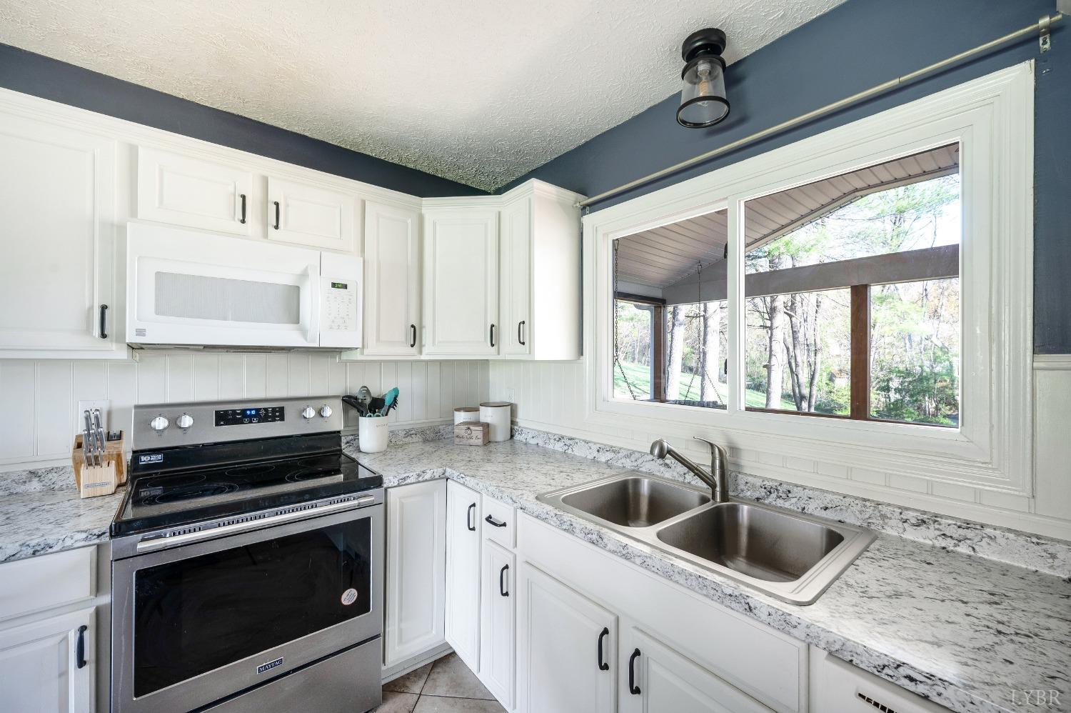 503 Sweeney Circle Forest, VA 24551 - Photo 9 of 50 a kitchen with granite countertop a sink and a stove top oven