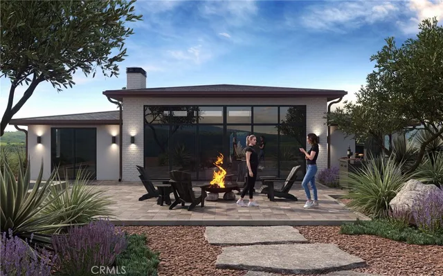 a view of a house with potted plants and a bench